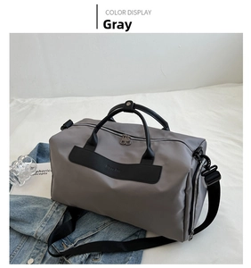 Macro detail of a grey travel bag with reinforced black straps and durable nylon texture