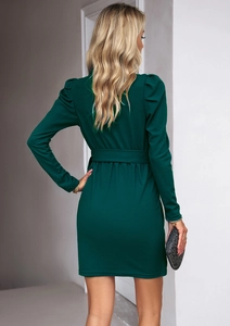 Vista posteriore di un abito corto verde elegante a maniche lunghe con cintura e spalline