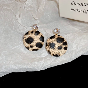 Detail view of leopard print hoop earrings with gold-plated star and sparkling rhinestone