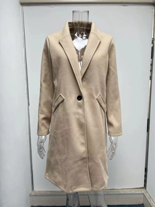 Detailed view of the notch lapel and single-button closure on the beige wool coat