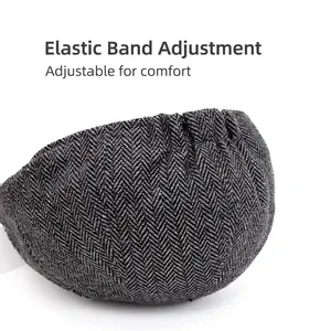 Grey herringbone newsboy hat featuring an adjustable elastic strap for comfortable fitting