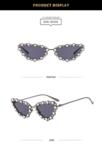 Close-up of cat-eye sunglasses with rhinestone-encrusted metal frames and dark lenses