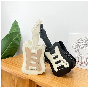 Detail of guitar-shaped crossbody bags featuring silver rivets and star metal accents