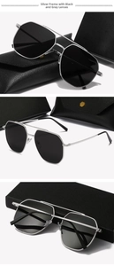 Detail view of silver metal aviator sunglasses with dark grey lenses and leather case