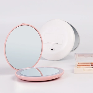 Portable LED travel makeup mirror with folding dual-sided 2X magnification in pink and white