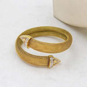 Macro shot of gold mesh wrap bracelet featuring sparkling rhinestone accents and metallic finish