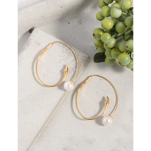 Minimalist S925 sterling silver gold spiral earrings with white pearls on a grey surface