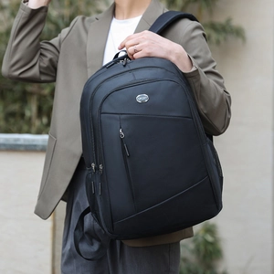 Black business casual backpack with multiple compartments and a metal Sport logo tag