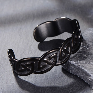 Macro view of black stainless steel Viking bracelet with intricate Celtic knot patterns