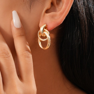 On-model view of geometric gold multi-ring earrings with elegant minimalist design