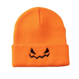 Orange Halloween pumpkin face knitted beanie hat made of warm acrylic yarn for fall winter
