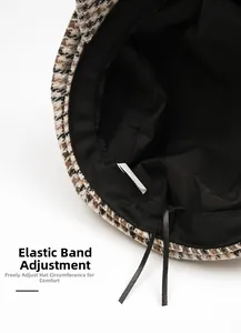 Detail of checkered newsboy cap interior featuring adjustable drawstring and sweatband