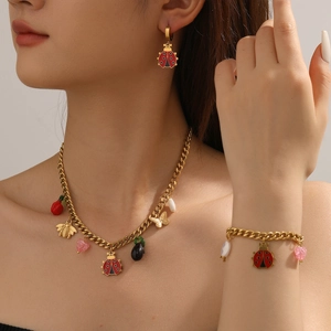 Golden insect jewelry set featuring ladybug bee and butterfly pendants on necklace