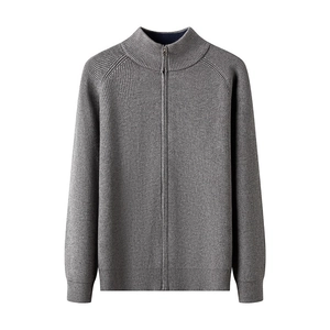 Detailed texture of gray knit cardigan featuring contrast zipper and vertical collar