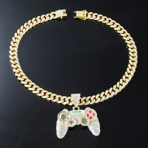 Close-up of iced out game controller pendant on gold cuban chain with MR.J lettering