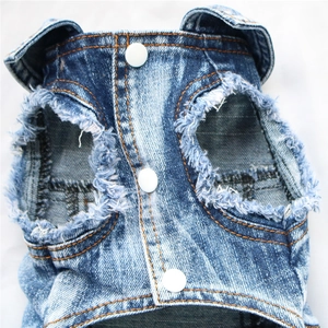 Close-up of pet denim vest featuring orange stitching and frayed sleeve details