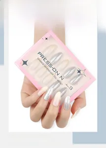 Close-up of silver glitter and nude gradient press-on nails in a pink box packaging