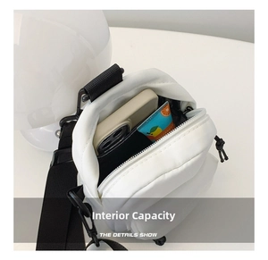 Close-up of white nylon crossbody bag interior showing spacious room for a smartphone