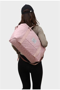 Detailed back view of a pink quilted yoga travel bag showing large capacity and satin finish