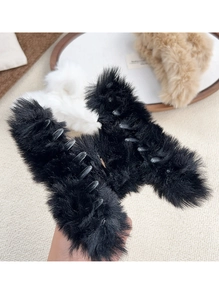 Close-up of plush faux fur hair claw clip in black with sturdy transparent comb teeth