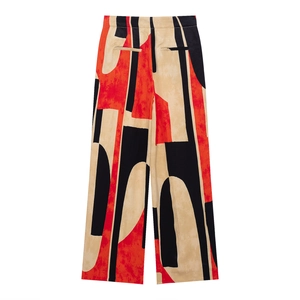Flat lay of trousers with abstract geometric print in red and black colors