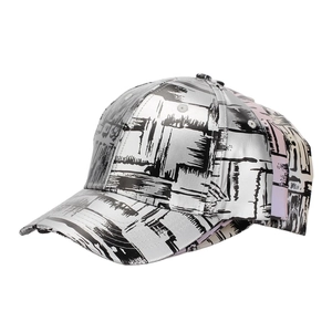 Detail of silver metallic PU baseball cap with black graffiti print and side color splicing
