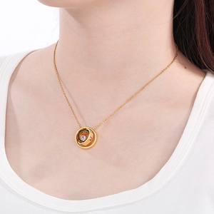 Detail of interlocking gold rings pendant with zircon stone and LOVE engraving on model