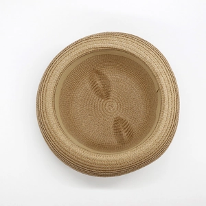 Top view of brown straw sun hat with cute cat ears and tight spiral weave texture