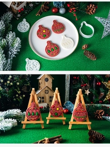 Detailed Christmas ornament cookie molds with embossed patterns on red-brown dough