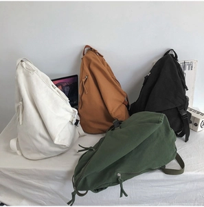 Detail of multi-color washed canvas backpacks with adjustable straps and sturdy zippers