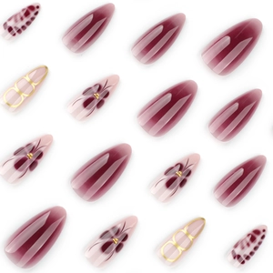 Burgundy and nude almond press-on nails with leopard print and floral gold accents