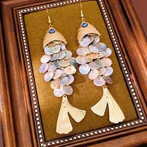 Vintage fish earrings with colorful shells, evil eye detail, and gold hook style