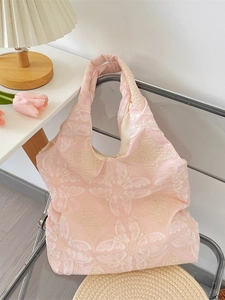 Pink canvas tote bag featuring delicate butterfly embroidery on a transparent chair