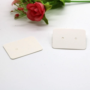 Close-up of two white rounded rectangular earring display cards with a red rose
