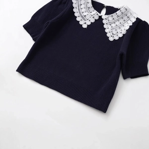 Navy blue short sleeve knit sweater with white floral lace collar flat lay view