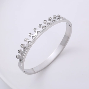 Elegant silver crown-shaped wave bangle set with sparkling cubic zirconia on white background