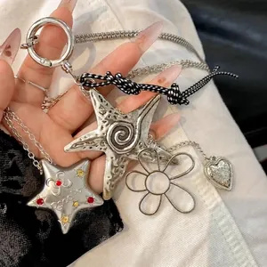 Chic star and heart pendant necklace featuring mixed metal charms and woven cord chain