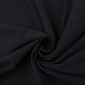Macro view of black glitter fabric with spiral pleated texture and elegant drape
