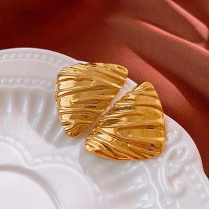 Minimalist gold floral earrings with flowing texture and irregular geometric shape
