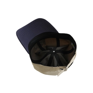 Inside view of a two-tone kids baseball cap with navy brim and beige panels