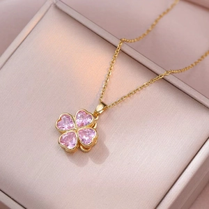 Rotating four-leaf clover necklace with pink heart crystals and gold titanium chain