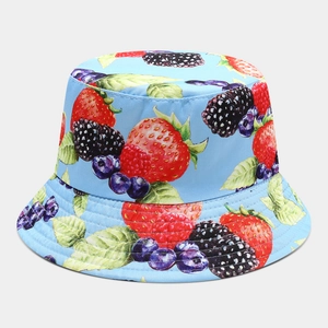 Detail of light blue bucket hat featuring realistic strawberry and blueberry print