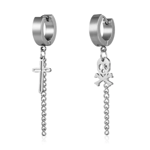 Detail of silver stainless steel asymmetrical earrings with skull and cross charms