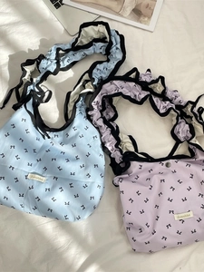 Lavender and light blue tote bags with bow prints and ruffled shoulder straps on white fabric