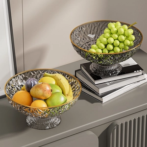 Detail of stacked crystal-textured fruit bowls with golden rims and tall bases