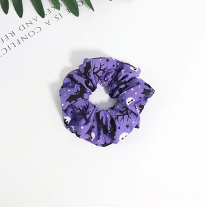 Halloween purple scrunchie with bat and ghost patterns on white background