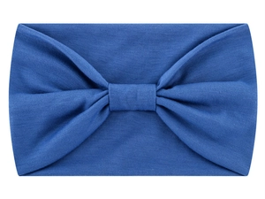 Detail of blue knitted cotton headband with a centered knot design on white background