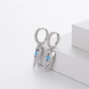 Detailed macro view of heart hoop earring with blue opal stone and white zircon accents