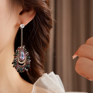 Detailed close-up of water drop tassel earrings with iridescent crystals and colorful beads