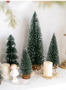 Mini green flocked Christmas trees with snow effect and wooden bases for table decor